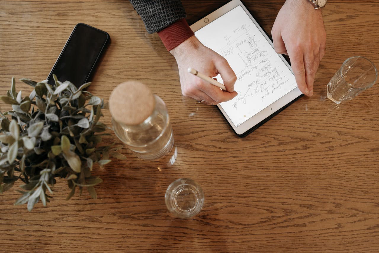 Person Writing on an Ipad Using an Apple Pencil